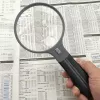 Suurennuslasi Carson Split Handle HF-11 — 3,5× käsisuurennuslasi, musta/läpinäkyvä, AAA-paristo